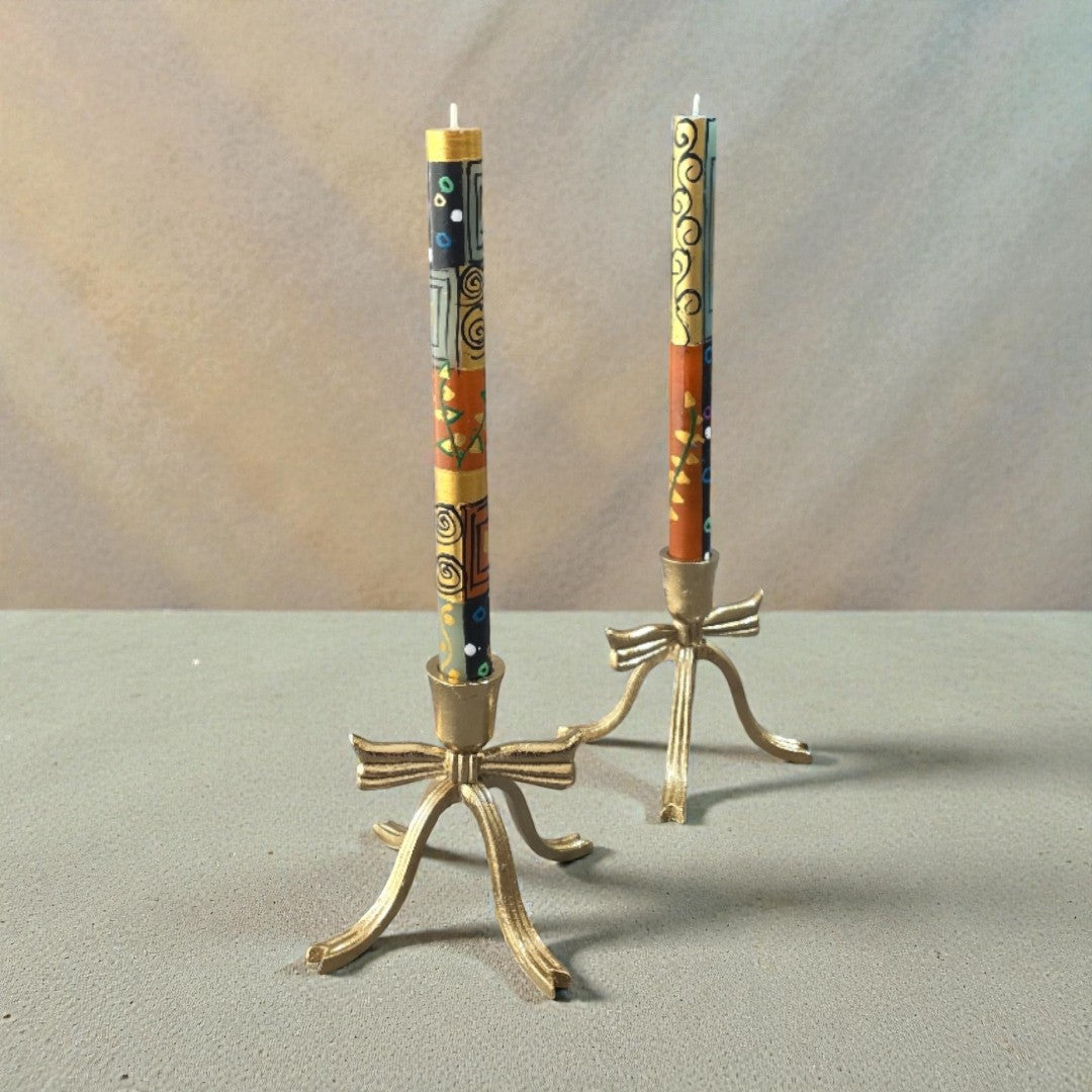 Earthy hand-painted taper dinner candles in warm terracotta tones