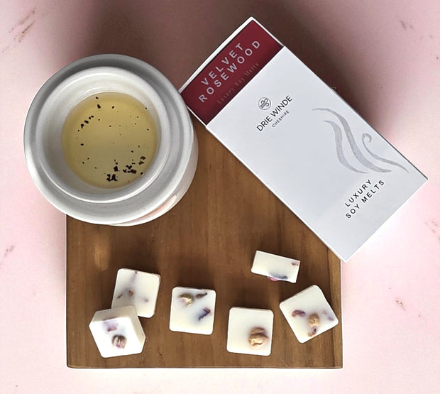 Soy wax melts with a container and packaging on a wooden board