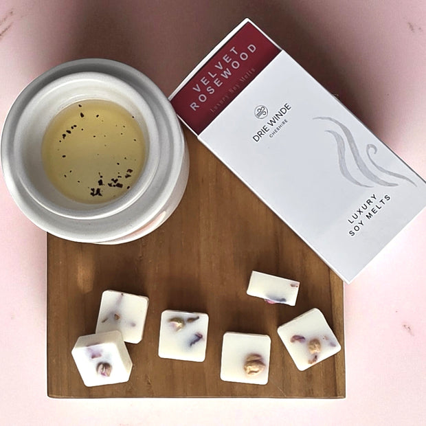 Soy wax melts with a container and packaging on a wooden board